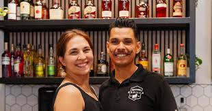 Business owner with ABIERTO sign