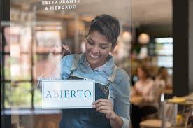 Shop owner with open sign